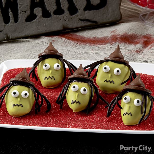 Strawberries decorated like witch faces